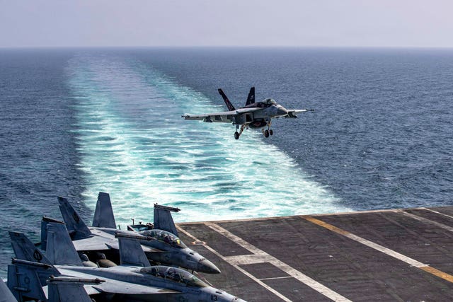 An F/A-18E Super Hornet preparing to land on the USS Abraham Lincoln after a mission in support of Operation Epic Fury 