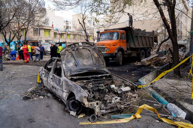 A damaged car after the air strikes on Tehran