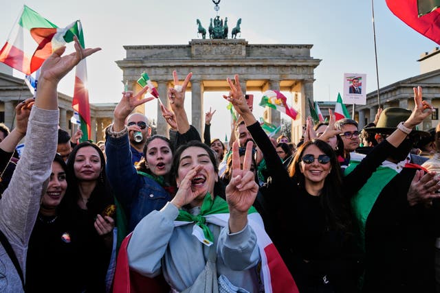 Iranian people attend a demonstration in support of the US and Israeli strikes on Iran, in front of the Brandenburg Gate in Berlin, Germany 