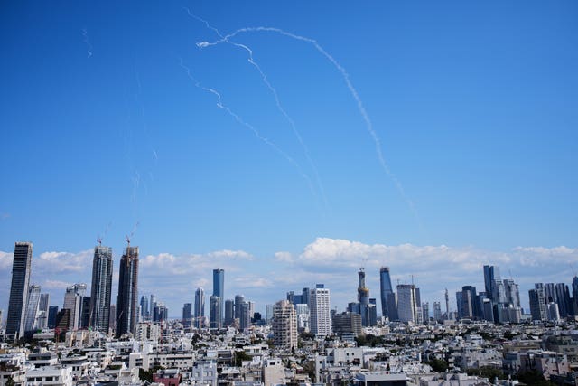 Air defence system fired in a blue sky to intercept a missile, over a city