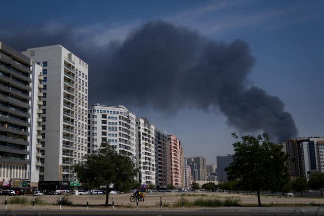 A black plume of smoke rising from a warehouse in Sharjah City in the United Arab Emirates