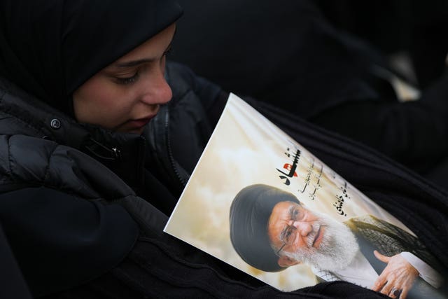 A woman cries as she mourns the death of Iranian Supreme Leader Ayatollah Ali Khamenei, during a gathering in the southern Suburb of Beirut, Lebanon