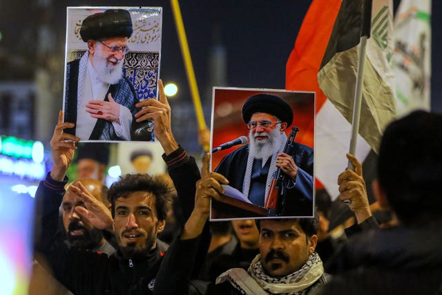Iraqi Shias hold pictures of Iranian Supreme Leader Ayatollah Ali Khamenei, who was killed by a US air strike in Tehran, during a symbolic funeral, in Najaf, Iraq 