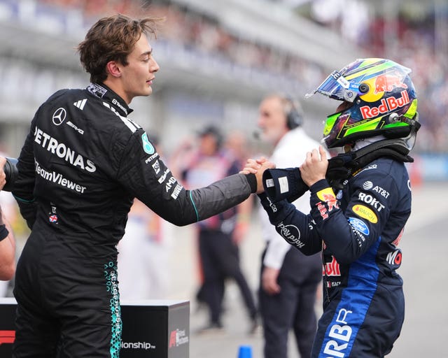 Mercedes driver George Russell, left, of Britain is congratulated by third placed Red Bull driver Isack Hadjar of France