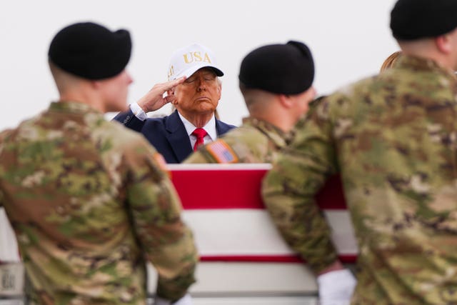 President Donald Trump salutes as the remains of US soldiers killed in the war are returned
