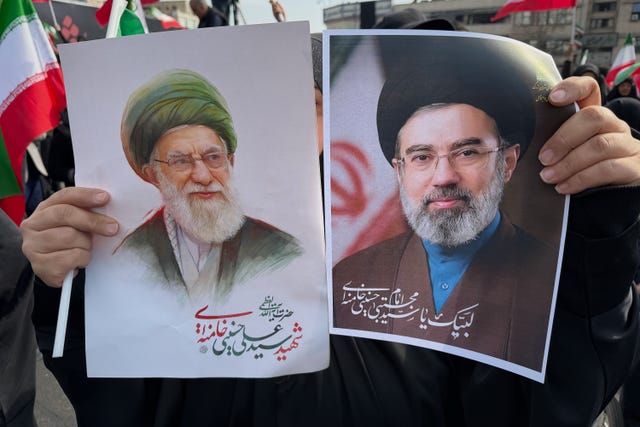 A woman holds posters of Ayatollah Mojtaba Khamenei, right, the successor to his late father, Ayatollah Ali Khamenei, left, as supreme leader, during a rally supporting him in Tehran, Iran 