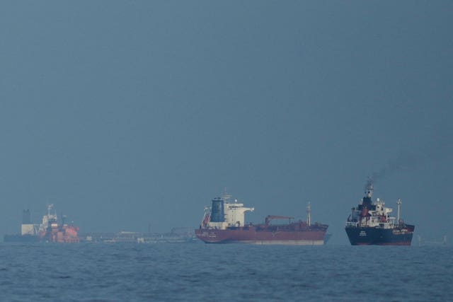 Oil tankers and cargo ships line up in the Strait of Hormuz as seen from Khor Fakkan in the United Arab Emirates 