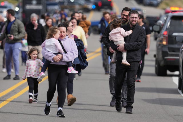 Law enforcement escort families with children away