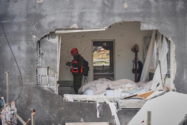 Officers from Israel’s Home Front Command inspect a house destroyed by an Iranian missile strike in Zarzir, northern Israel 