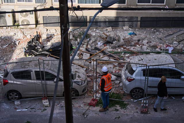 Israeli authorities inspect the site of a direct hit from an Iranian missile in Ramat Gan, Israel 