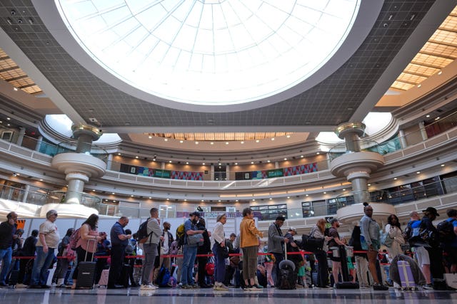 People wait in a TSA line at the Hartsfield-Jackson Atlanta International Airport in Atlanta