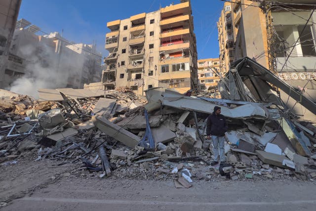 A man stands on the rubble of a destroyed building that was hit by an Israeli air strike in Dahiyeh, Beirut’s southern suburbs, Lebanon 