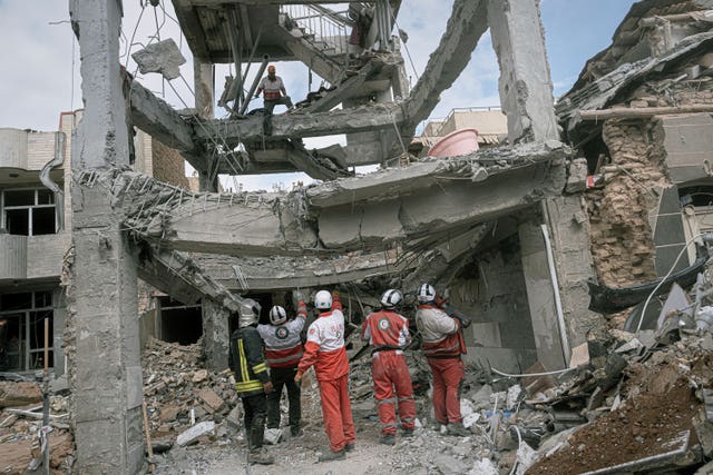 Rescue workers at a building in northwestern Iran