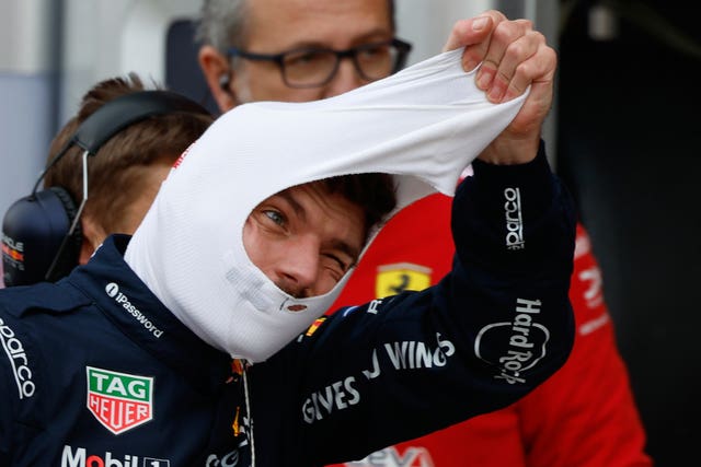 Red Bull driver Max Verstappen takes off his protection hood