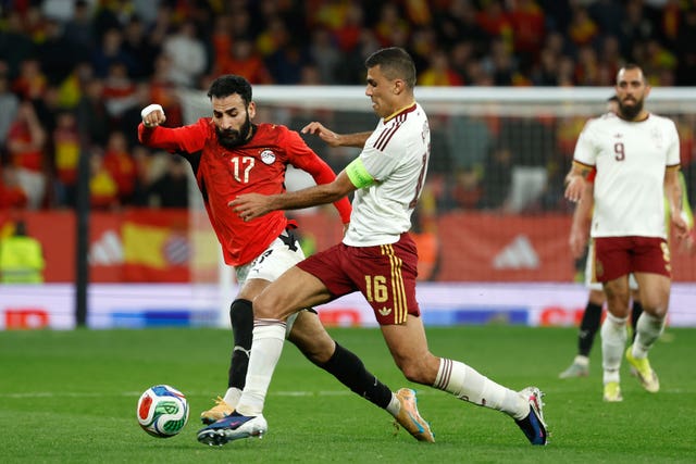 Spain’s Rodri, right, challenges for the ball with Egypt’s Mohanad Lasheen