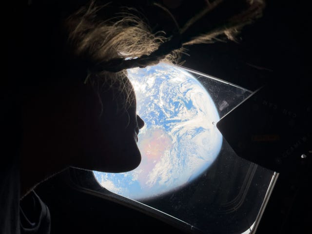 Christina Koch gazes back at Earth from of one of the Orion spacecraft&rsquo;s main cabin windows
