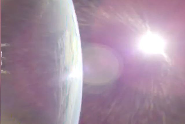This image taken from video provided by NASA shows the Earth, left, from Nasa&rsquo;s Orion spacecraft as it fired its engines heading toward the Moon