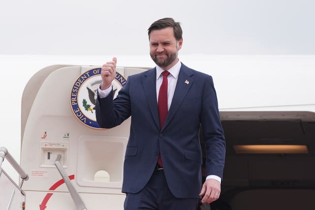 JD Vance smiling and giving the thumbs up while exiting Air Force Two