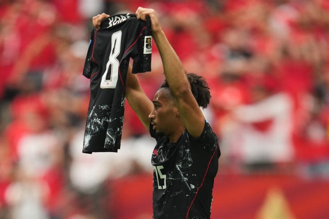 Nathan Saliba holds up Ismael Kone's number eight jersey, after he came on for him and scored against Qatar 
