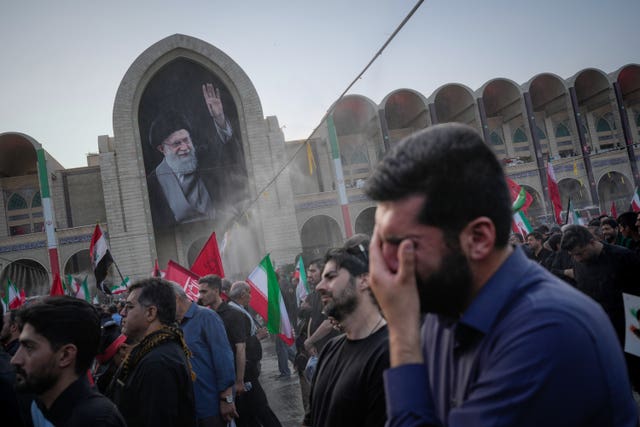 A mourner weeps during the funeral ceremonies for slain Iranian Supreme Leader Ayatollah Ali Khamenei and members of his family at the Imam Khomeini Mosalla Grand Mosque in Tehran