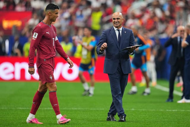 Roberto Martinez (right) gives instructions to Cristiano Ronaldo