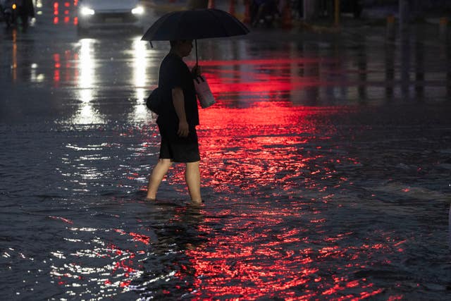 Someone walks through a flooded junction