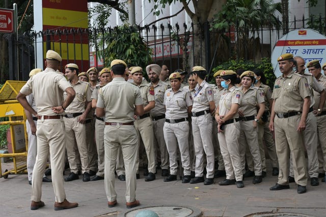 A police officer briefs fellow officers on a planned march
