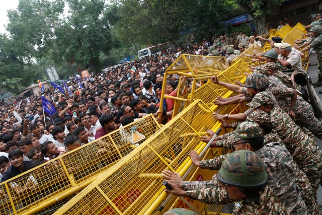 Supporters of the Cockroach Janta Party push against a barricade as they attempt to march to India’s Parliament