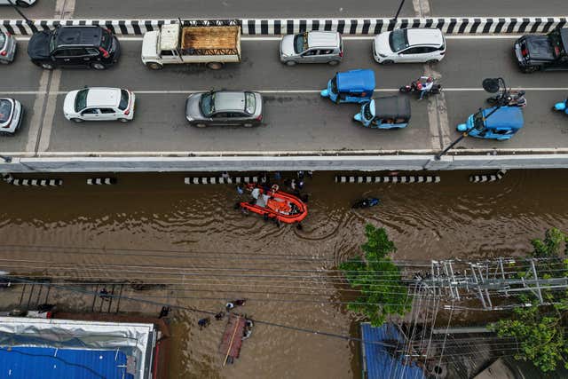 Cars on a bridge above a flooded road