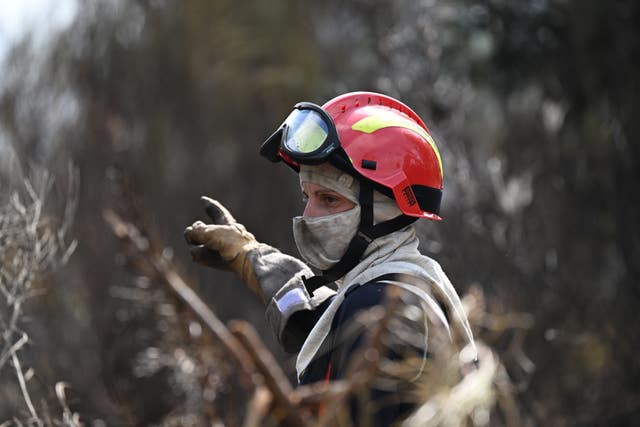 A firefighter works to extinguish fires in south-west France,