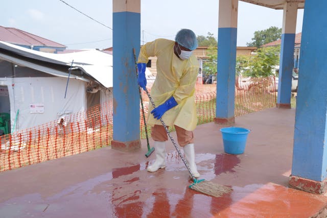 A health worker mops the floor of an Ebola treatment centre 