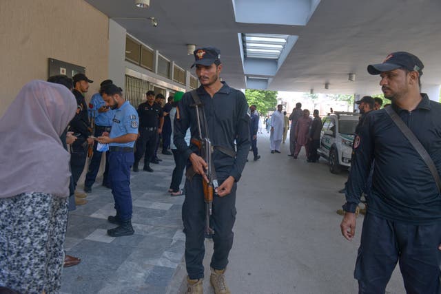 Police officers stand guard outside a nursery