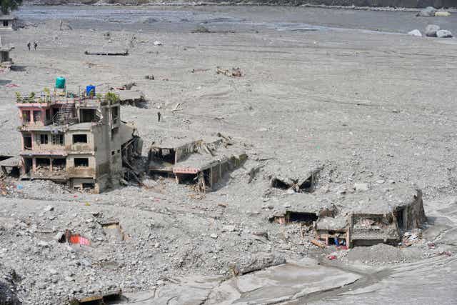 Damaged buildings in layers of sludge, mud and debris