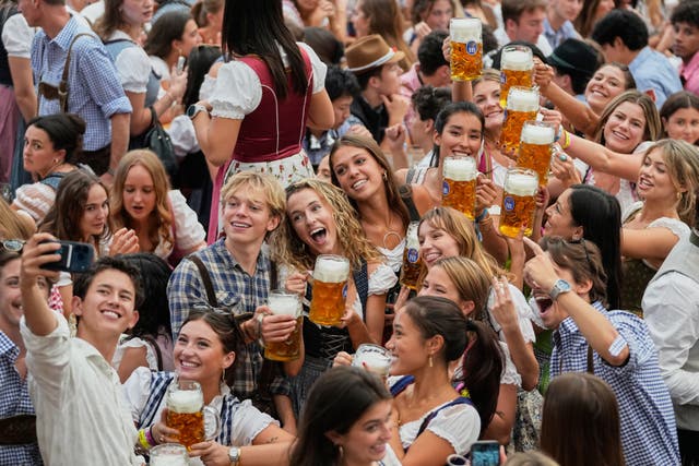 People cheering with pints raised 