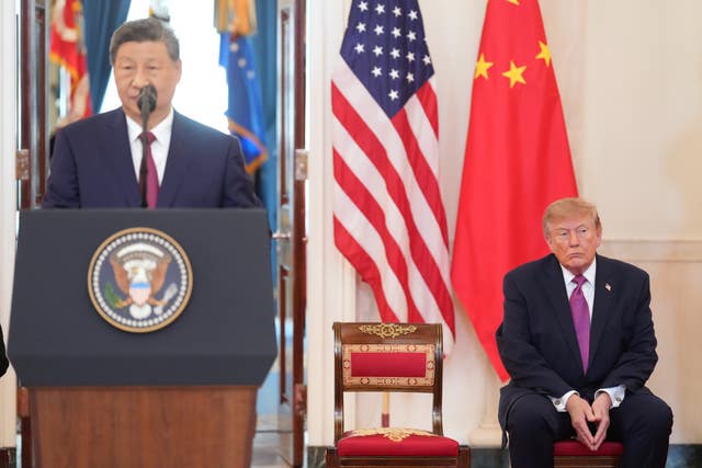 US President Donald Trump listens as Chinese President Xi Jinping speaks during the arrival ceremony