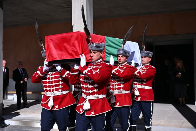 Military personnel carry the coffin