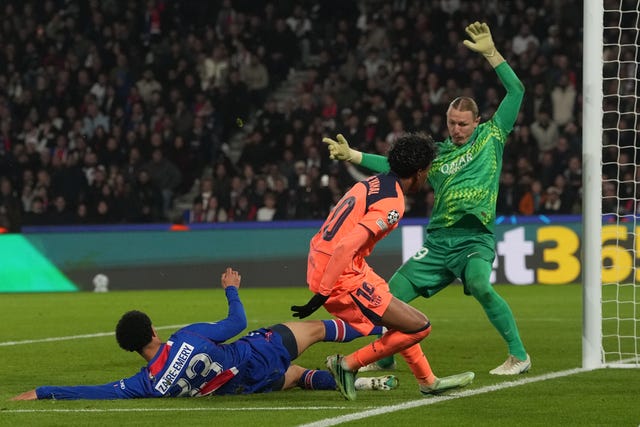 Barcelona’s Lamine Yamal, centre, scores his side’s second goal past PSG keeper Matvey Safonov, right