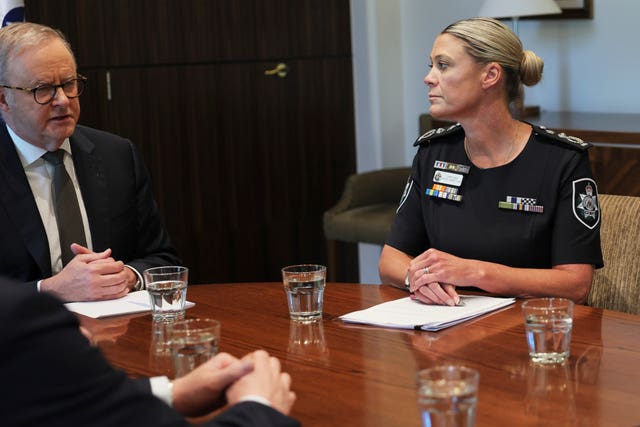 Prime Minister Anthony Albanese talking to Australian Federal Police commissioner Krissy Barrett