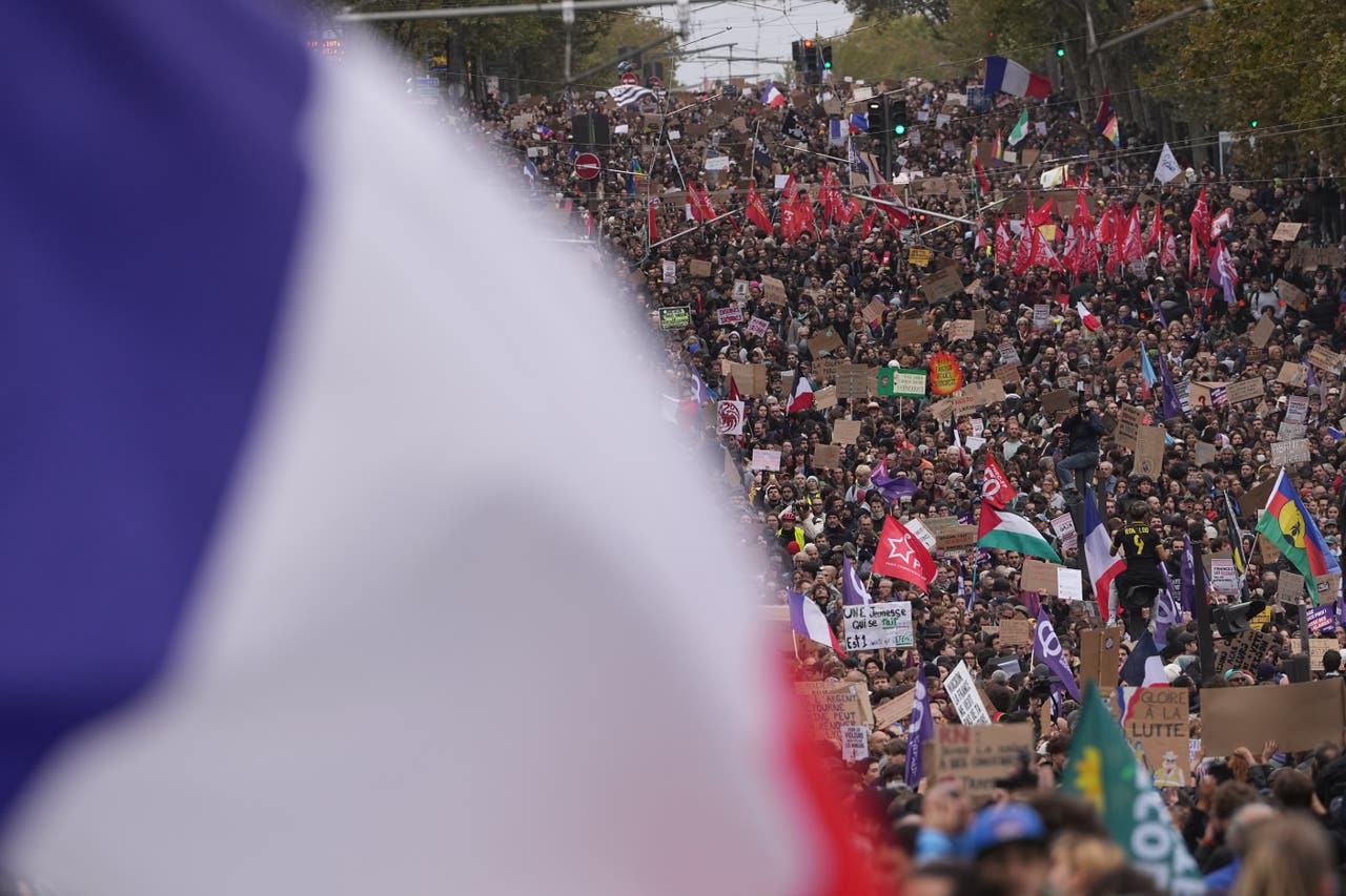 Mass protests challenge Macron as French police use tear gas and water ...